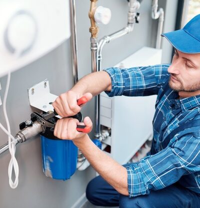 young-man-workwear-using-pliers-while-installing-water-filtration-system-kitchen-client_274679-5361